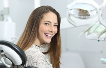 satisfied smiling woman patient at dental office